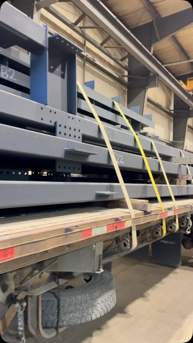 Fabricated steel strapped to a trailer for delivery